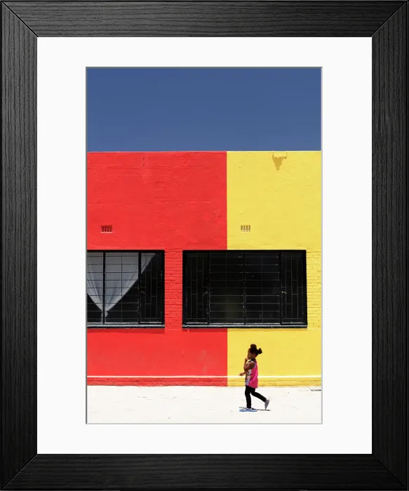 Framed Print : Little girl walking past colourful painted building, Kalkrand, Hardap Region, Namibia Framed Print : Little girl walking past colourful painted building, Kalkrand, Hardap Region, Namibia