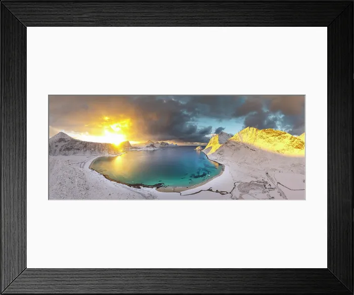Framed Print : Aerial view of the snowy Haukland beach and turquoise water of a fjord under a burning sky at dawn, Lofoten Islands, Norway
