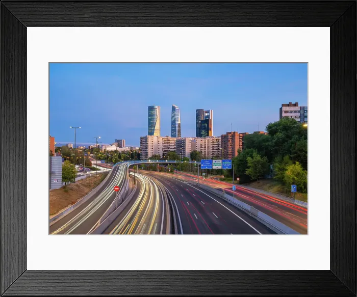 Framed Print : Car light trails on urban highway with Four Towers Business district in Paseo de la Castellana at twilight, Madrid, Spain Framed Print : Car light trails on urban highway with Four Towers Business district in Paseo de la Castellana at twilight, Madrid, Spain