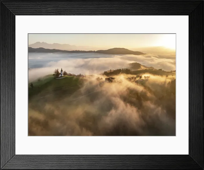 Framed Print : Aerial view of the Church of St. Thomas in mist at dawn, in autumn, Skofja Loka, Slovenia Framed Print : Aerial view of the Church of St. Thomas in mist at dawn, in autumn, Skofja Loka, Slovenia