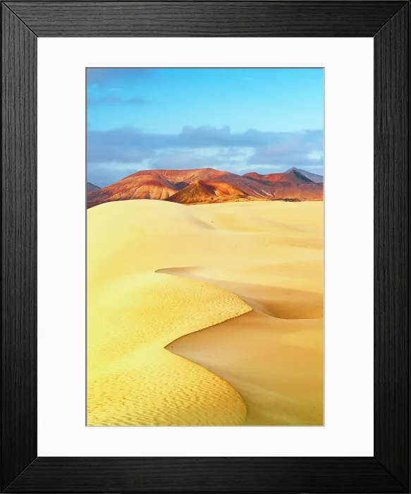 Framed Print : Golden sand dunes with volcanic mountains on background at dawn, Corralejo Natural Park, Fuerteventura, Canary Islands, Spain Framed Print : Golden sand dunes with volcanic mountains on background at dawn, Corralejo Natural Park, Fuerteventura, Canary Islands, Spain