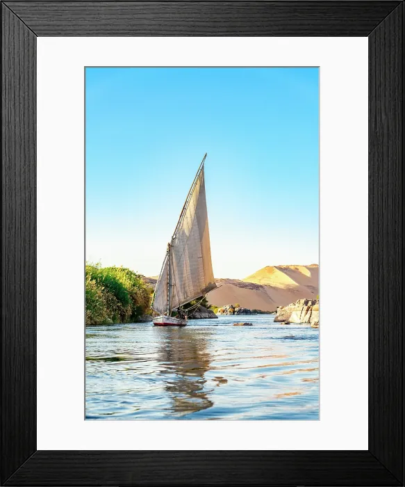 Framed Print : A felucca sails on the Nile River near the Aswan cataracts, Egypt