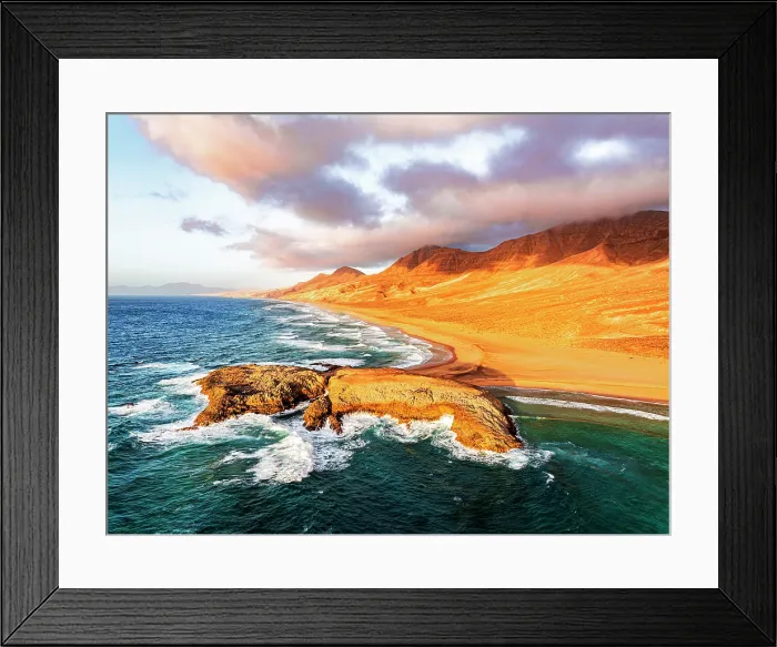 Framed Print : Aerial view of rocky islet at Cofete beach washed by ocean waves, Jandia Natural Park, Fuerteventura, Canary Islands, Spain Framed Print : Aerial view of rocky islet at Cofete beach washed by ocean waves, Jandia Natural Park, Fuerteventura, Canary Islands, Spain