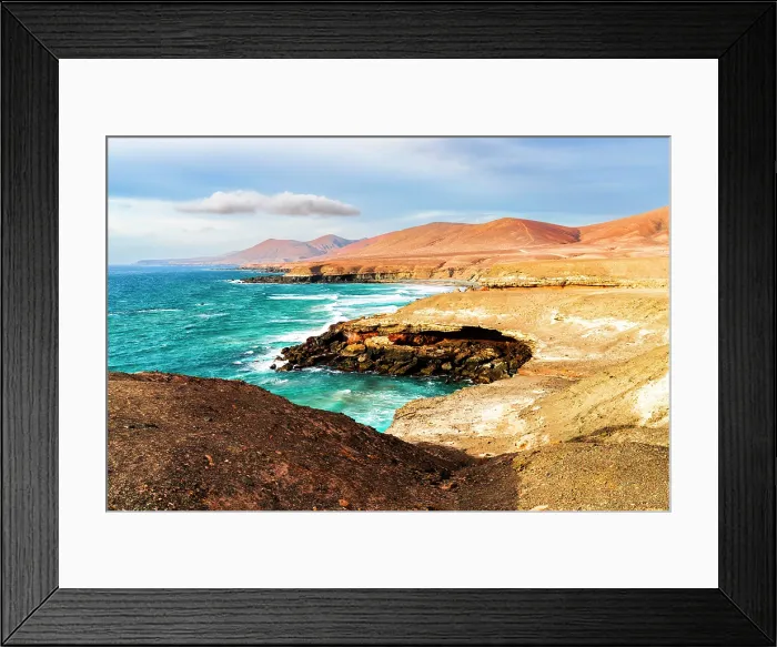 Framed Print : Ocean waves crashing on Playa De Garcey beach surrounded by volcanic cliffs, Fuerteventura, Canary Islands, Spain Framed Print : Ocean waves crashing on Playa De Garcey beach surrounded by volcanic cliffs, Fuerteventura, Canary Islands, Spain