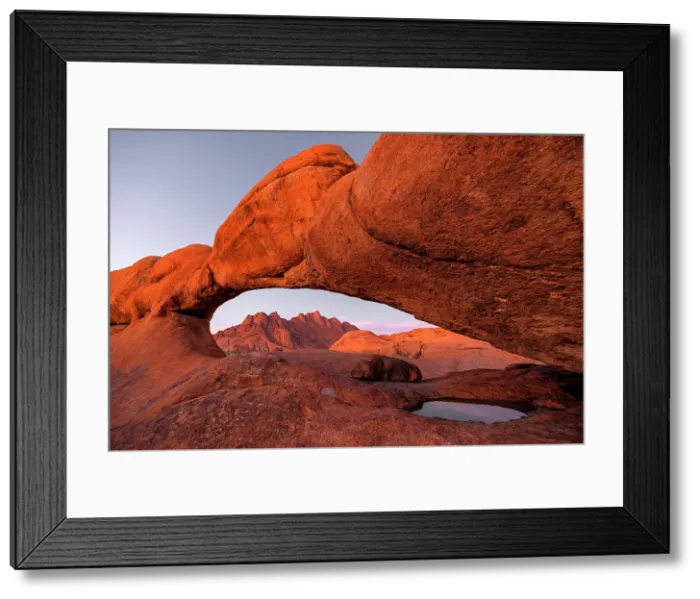 Framed Print : Ancient granite mountains and natural rock arch at dusk, Spitzkoppe, Namib Desert, Namibia Framed Print : Ancient granite mountains and natural rock arch at dusk, Spitzkoppe, Namib Desert, Namibia