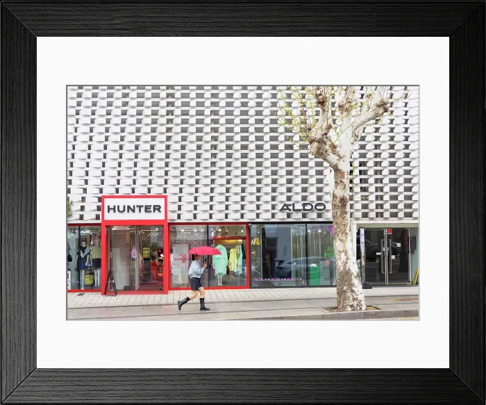Framed Print : Woman walking past shop in Itaewon Dong area, Seoul, South Korea Framed Print : Woman walking past shop in Itaewon Dong area, Seoul, South Korea