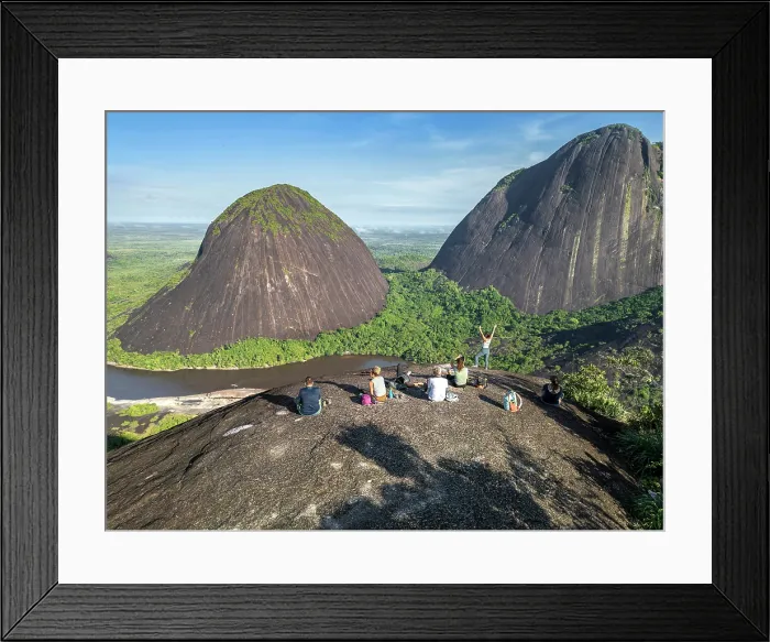 Framed Print : Americas, South America, Colombia, Puinave Indigenous Reserve, aerial view of the Cerros de Mavecure mountains; hikers sitting on the summit