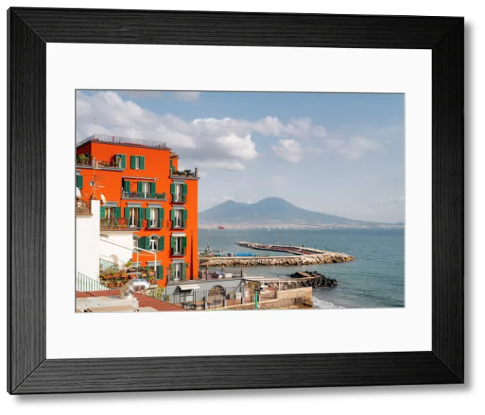 Framed Print : Naples, Italy: Colorful architecture meets the sea, with Mount Vesuvius in the distance. Posillipo Framed Print : Naples, Italy: Colorful architecture meets the sea, with Mount Vesuvius in the distance. Posillipo