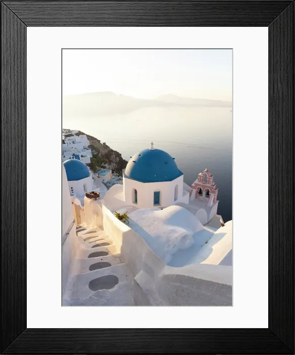 Framed Print : Blue domed churches, white-washed houses and steps with caldera view in the distance, Oia, Santorini, Cyclades Islands, Greece Framed Print : Blue domed churches, white-washed houses and steps with caldera view in the distance, Oia, Santorini, Cyclades Islands, Greece