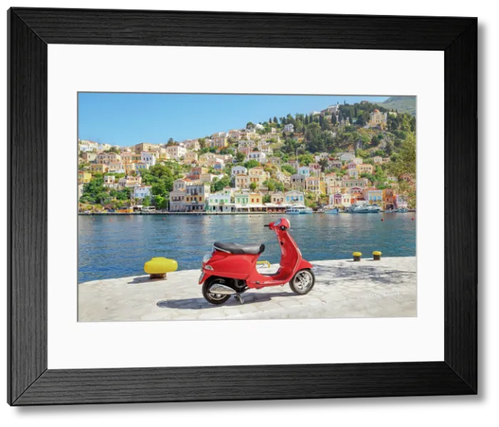 Framed Print : Red vespa scooter parked at Gialos harbour, Gialos, Symi Island, Dodecanese Islands, Greece