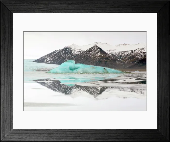 Framed Print : Iceberg and snow covered mountains reflecting in glacial water, Jokulsarlon Glacier Lagoon, South Iceland
