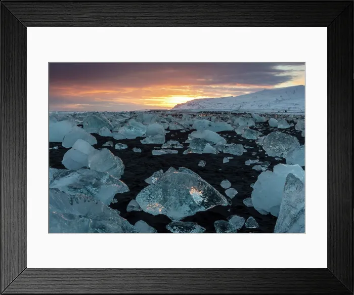 Framed Print : Black volcanic sand beach covered in icebergs from Jokulsarlon glacier lagoon, at sunset, Southeast Iceland Framed Print : Black volcanic sand beach covered in icebergs from Jokulsarlon glacier lagoon, at sunset, Southeast Iceland