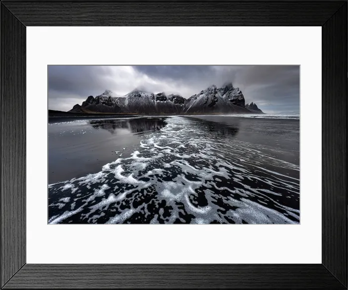 Framed Print : Surf from waves on black volcanic sand beach with Vestrahorn in the distance, Stokksnes, South Iceland