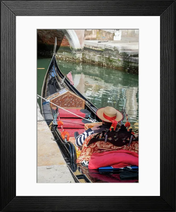Framed Print : Gondolier resting on a moored gondola boat, Venice, Veneto, Italy Framed Print : Gondolier resting on a moored gondola boat, Venice, Veneto, Italy
