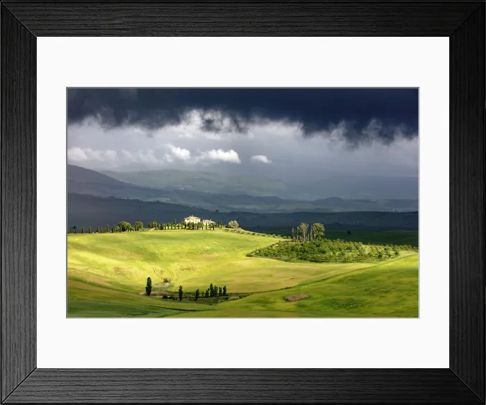 Framed Print : Sunlit farmhouse and green fields beneath a dark, stormy sky, Val d'Orcia, near Pienza, Tuscany, Italy Framed Print : Sunlit farmhouse and green fields beneath a dark, stormy sky, Val d'Orcia, near Pienza, Tuscany, Italy