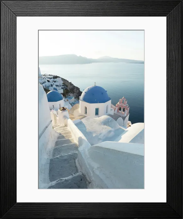 Framed Print : Blue domed churches, white-washed houses and steps with caldera view in the distance, Oia, Santorini, Cyclades Islands, Greece Framed Print : Blue domed churches, white-washed houses and steps with caldera view in the distance, Oia, Santorini, Cyclades Islands, Greece