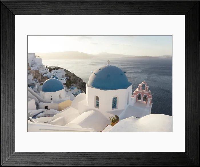 Framed Print : Blue domed churches and white-washed houses with caldera view in the distance, Oia, Santorini, Cyclades Islands, Greece Framed Print : Blue domed churches and white-washed houses with caldera view in the distance, Oia, Santorini, Cyclades Islands, Greece
