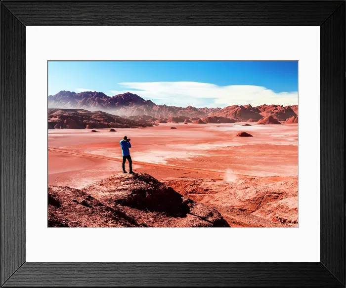Framed Print : Man on rocks photographing the red Devil's Desert, Puna, Argentina. (MR) Framed Print : Man on rocks photographing the red Devil's Desert, Puna, Argentina. (MR)
