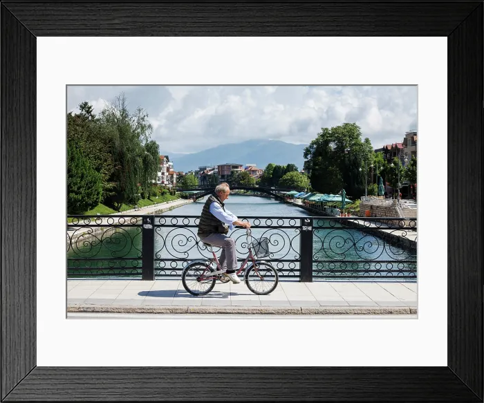 Framed Print : Cyclist on traditional bridge, Struga, North Macedonia Framed Print : Cyclist on traditional bridge, Struga, North Macedonia