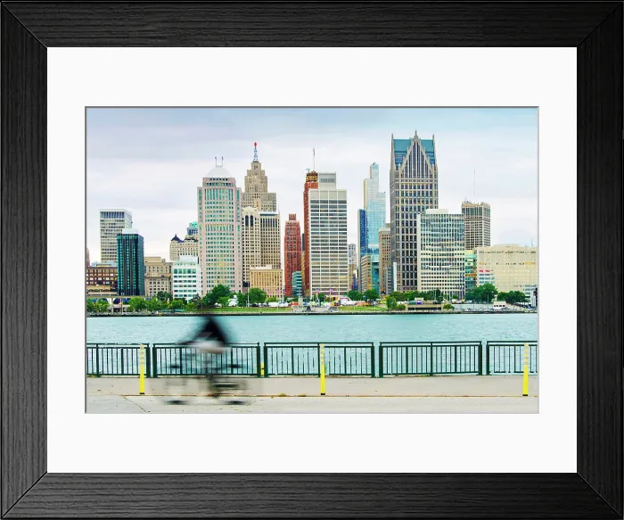 Framed Print : USA, Detroit, Michigan, Skyline View From Windsor, Canada Riverfront Trail, Across The Detroit River, New Hudson Building, Blurred Bicycle Rider Framed Print : USA, Detroit, Michigan, Skyline View From Windsor, Canada Riverfront Trail, Across The Detroit River, New Hudson Building, Blurred Bicycle Rider