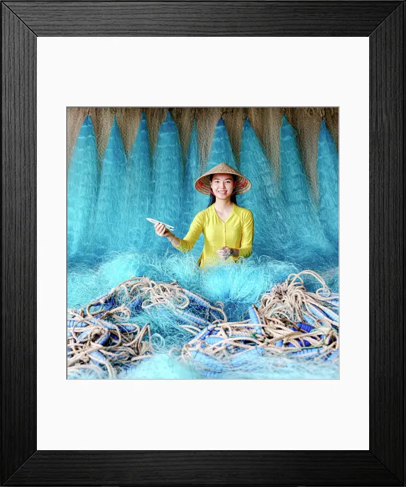 Framed Print : Woman repairing a blue fishing net, Vietnam. (MR) Framed Print : Woman repairing a blue fishing net, Vietnam. (MR)