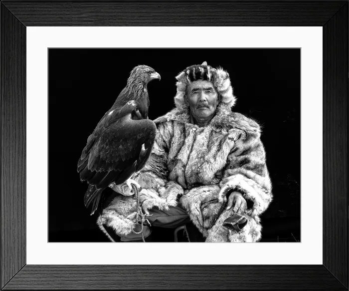 Framed Print : Black & white portrait of a Kazakh Eagle Hunter wearing traditional fur clothing and posing with his trained golden eagle, Bayan-Ulgii Province, Western Mongolia, Asia