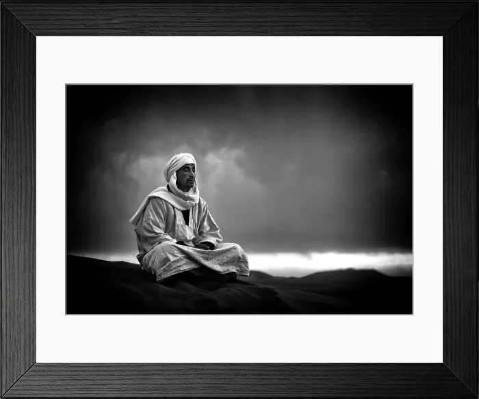 Framed Print : Portrait of a Berber man wearing traditional Djellaba and cheche (headscarf), sitting on a sand dune, Sahara Deseret, near, Merzouga Morocco Framed Print : Portrait of a Berber man wearing traditional Djellaba and cheche (headscarf), sitting on a sand dune, Sahara Deseret, near, Merzouga Morocco