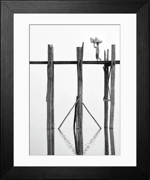 Framed Print : Local woman carrying goods on her head across U Bein Bridge, the world's longest teak foot bridge spanning 1300 yards over Taungthaman Lake, Amarapura, near Mandalay, Myanmar Framed Print : Local woman carrying goods on her head across U Bein Bridge, the world's longest teak foot bridge spanning 1300 yards over Taungthaman Lake, Amarapura, near Mandalay, Myanmar