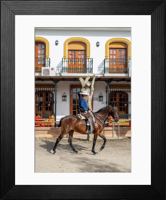 Framed Print : Horseman riding in a street during the Romeria de El Rocio pilgrimage, El Rocio, Huelva, Andalusia, Spain Framed Print : Horseman riding in a street during the Romeria de El Rocio pilgrimage, El Rocio, Huelva, Andalusia, Spain