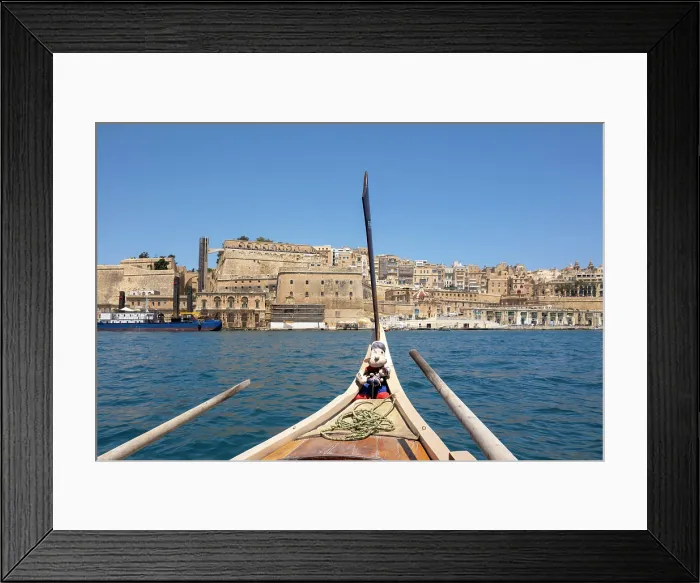 Framed Print : Views from a traditional water taxi towards Valletta with a Popeye Mascot, Valletta, Malta Framed Print : Views from a traditional water taxi towards Valletta with a Popeye Mascot, Valletta, Malta