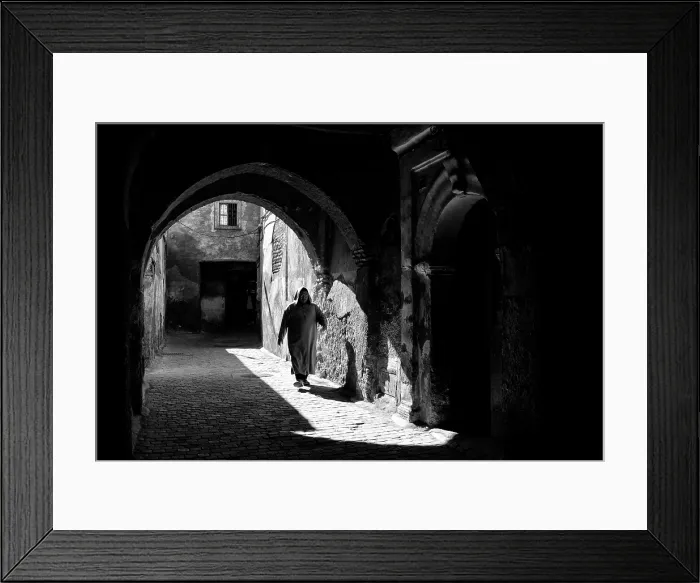 Framed Print : Local man in djellaba, walking through an archway on cobbled street, Medina, Marrakech, Morocco Framed Print : Local man in djellaba, walking through an archway on cobbled street, Medina, Marrakech, Morocco
