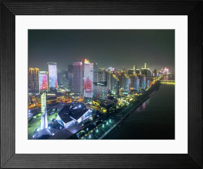 Framed Print : China, Hunan Province, Changsha City. Provincial capital of Hunan Province. City skyline showing illuminated skyscrapers in the evening, modern buildings and the Xiang River