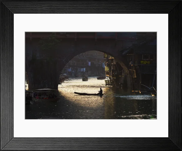 Framed Print : China, Zhonghua, Hunan, Fenghuang, A canoe passes under the fortified bridge on the river Tuo Framed Print : China, Zhonghua, Hunan, Fenghuang, A canoe passes under the fortified bridge on the river Tuo