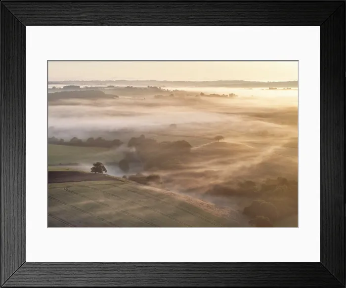 Framed Print : Mist shrouded rolling countryside at dawn, mid Devon, England. Summer (June) 2023