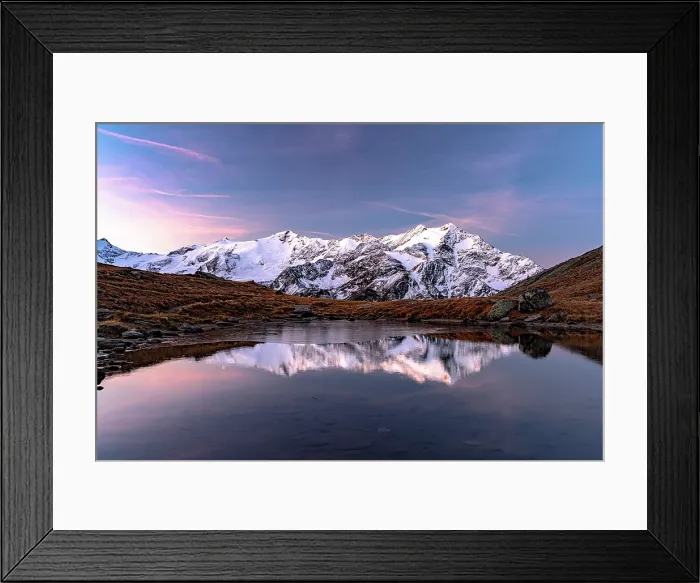 Framed Print : Snowy peaks reflected in water at dawn, Val Cedec, Valtellina, Lombardy, Italy