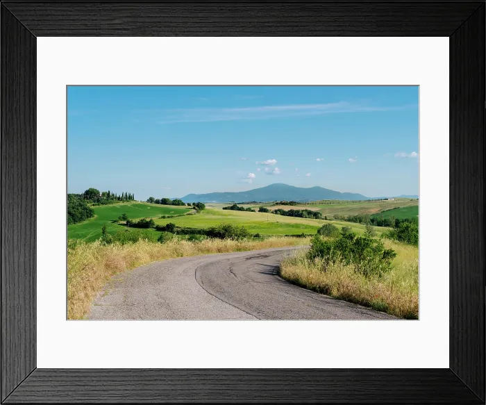 Framed Print : Italy, Tuscany, Crete Senesi: Winding road through rolling hills under a bright blue sky Framed Print : Italy, Tuscany, Crete Senesi: Winding road through rolling hills under a bright blue sky