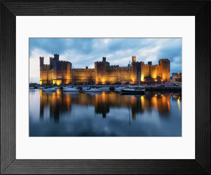 Framed Print : Caernarfon Castle (Castell Caernarfon) reflected in Afon Seiont at sunset, Caernarfon, Gwynedd, Wales