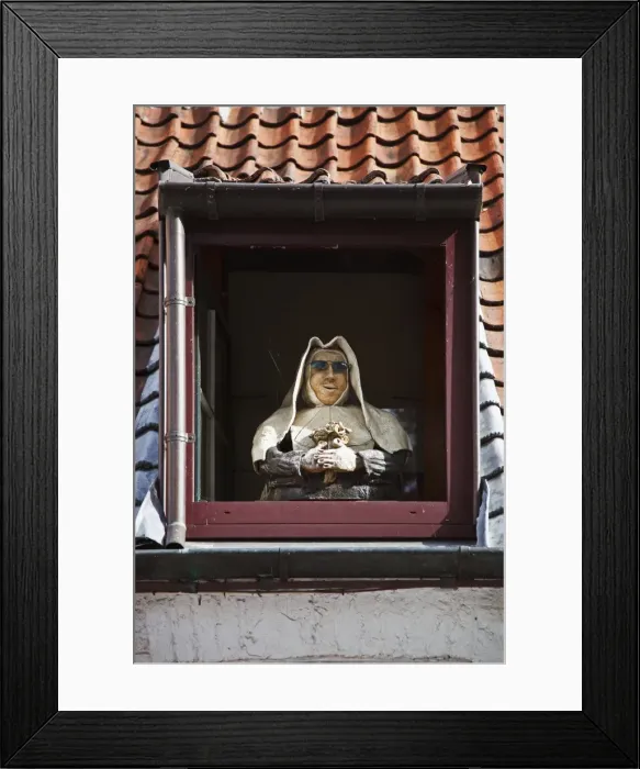 Framed Print : A mannequin nun stands in the dormwer window of a house in Brugge Sint Kruis Framed Print : A mannequin nun stands in the dormwer window of a house in Brugge Sint Kruis