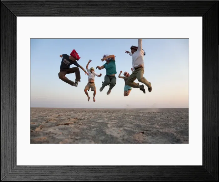 Framed Print : Botswana, Makgadikgadi. A family jump high in the air above the Makgadikgadi salt pans Framed Print : Botswana, Makgadikgadi. A family jump high in the air above the Makgadikgadi salt pans