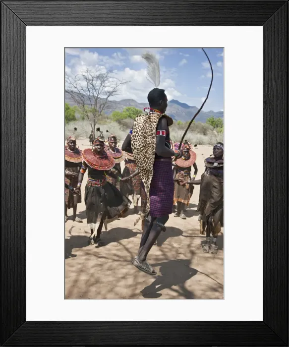 Framed Print : A Pokot warrior wearing a leopard skin jumps high in the air surrounded by women to celebrate an Atelo ceremony. The Pokot are pastoralists speaking a Southern Framed Print : A Pokot warrior wearing a leopard skin jumps high in the air surrounded by women to celebrate an Atelo ceremony. The Pokot are pastoralists speaking a Southern