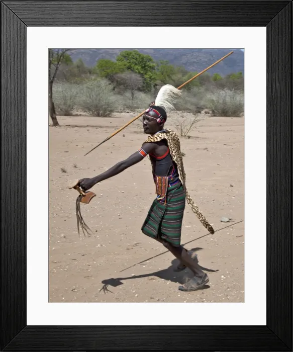 Framed Print : A Pokot warrior wearing a leopard skin cape celebrates an Atelo ceremony, spear in hand Framed Print : A Pokot warrior wearing a leopard skin cape celebrates an Atelo ceremony, spear in hand