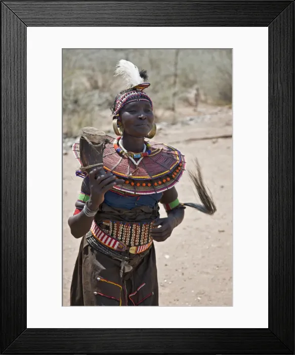 Framed Print : An old Pokot woman dancing during an Atelo ceremony. The cow horn container usually contains animal fat Framed Print : An old Pokot woman dancing during an Atelo ceremony. The cow horn container usually contains animal fat