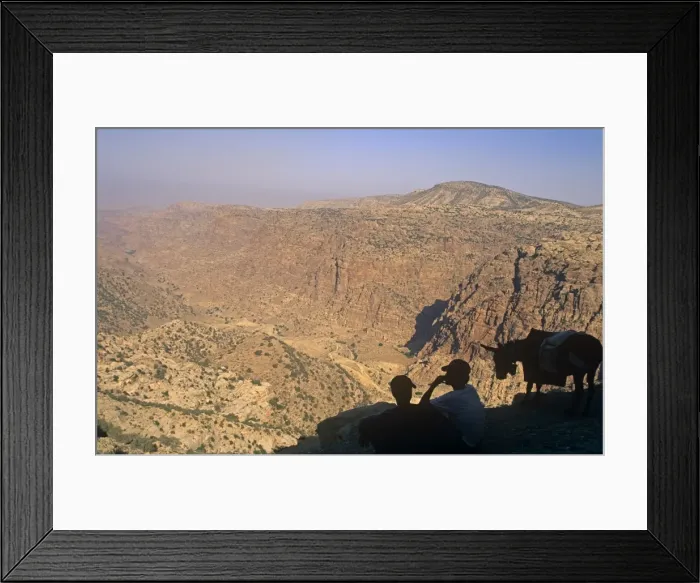 Framed Print : Jordan, Dana Biosphere Reserve. Dana village youths gaze over the spectacular lip of Wadi Dana towards Framed Print : Jordan, Dana Biosphere Reserve. Dana village youths gaze over the spectacular lip of Wadi Dana towards