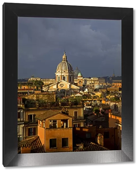 Rome, Italy; A narrowed overview of rooftops with the St. Peters Basilica Cupola on the horizon