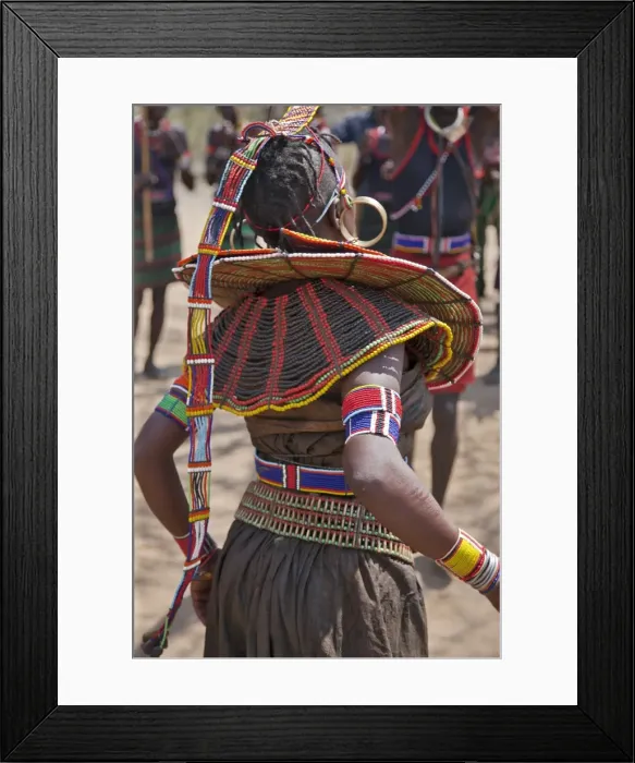 Framed Print : A Pokot woman in traditional attire dances to celebrate an Atelo ceremony Framed Print : A Pokot woman in traditional attire dances to celebrate an Atelo ceremony