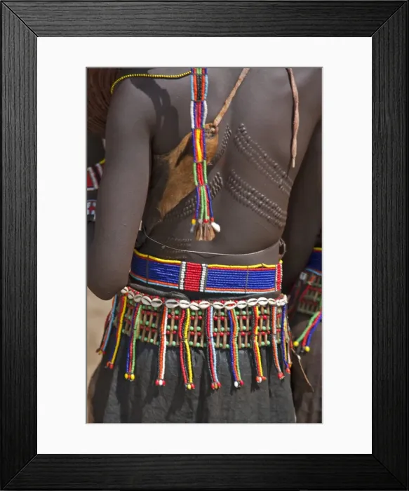 Framed Print : A Pokot woman in traditional attire with patterned cicatrices on her back attends an Atelo ceremony
