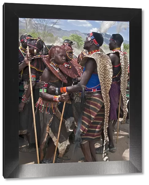 Pokot men, women and girls dancing to celebrate an Atelo ceremony. The Pokot are pastoralists speaking a Southern