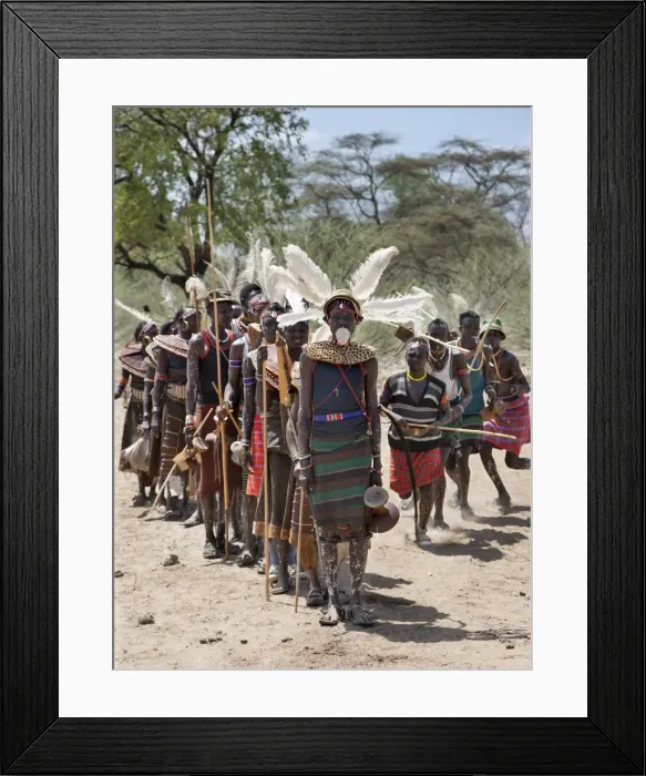 Framed Print : The Pokot have a small ceremony called Koyogho when a man pays his in-laws the balance of the agreed dowry for his wife. This may take place many years after he marries her. At the conclusion of the ritual, the man followed by his wife leads Framed Print : The Pokot have a small ceremony called Koyogho when a man pays his in-laws the balance of the agreed dowry for his wife. This may take place many years after he marries her. At the conclusion of the ritual, the man followed by his wife leads
