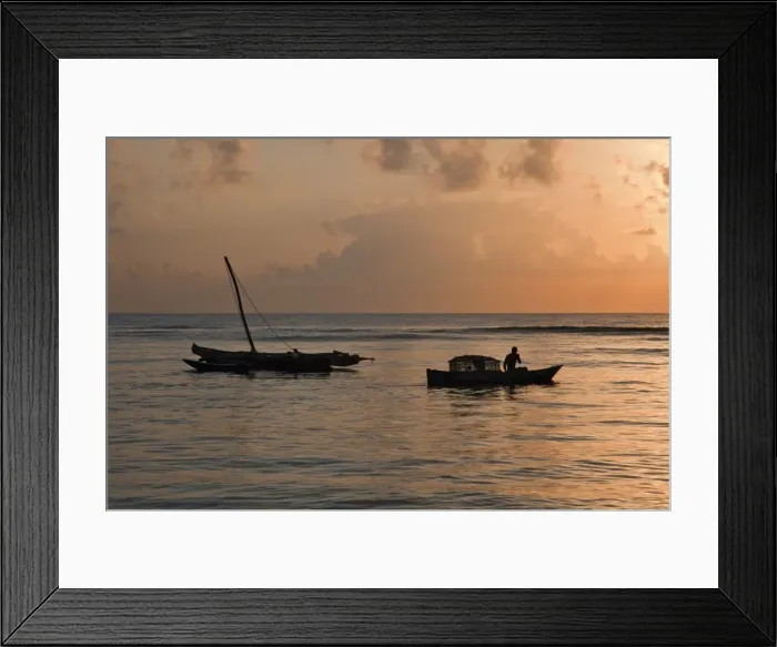 Framed Print : At dawn, a fisherman sets out from Msambweni, south of Mombasa, with a fish trap while an outrigger canoe is still anchored in Framed Print : At dawn, a fisherman sets out from Msambweni, south of Mombasa, with a fish trap while an outrigger canoe is still anchored in