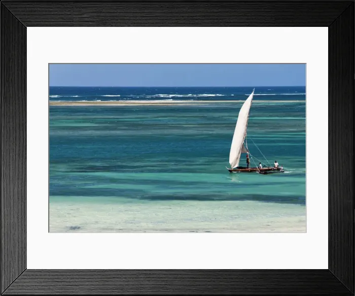 Framed Print : A traditional outrigger canoe sails close to the shore at Diani Beach